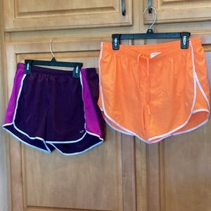 Two pairs of athletic shorts Danskin now and champion medium maroon and orange